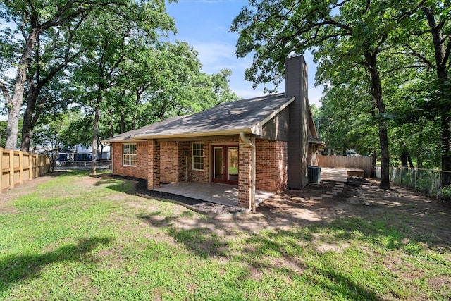 143 Doe Run Rd, Gun Barrel City, TX 75156 - back of property featuring french doors, a chimney, brick siding, and a patio