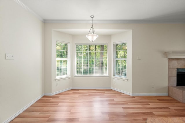 143 Doe Run Rd, Gun Barrel City, TX 75156 - unfurnished dining area with light wood finished floors, ornamental molding, a fireplace, and baseboards