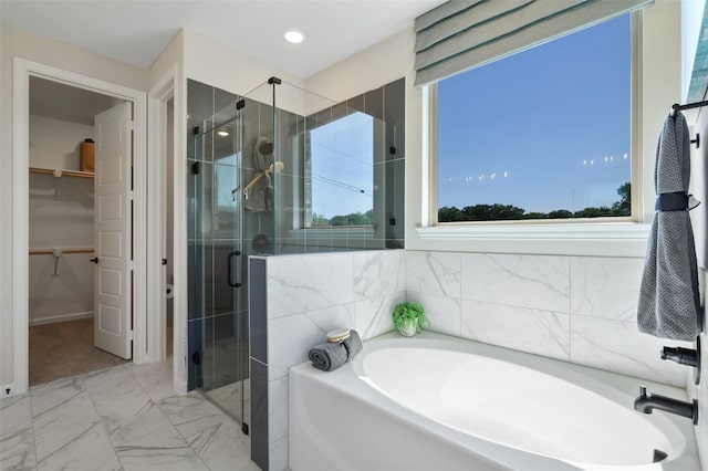1417 Red Clover Ave, Van Alstyne, TX 75495 - bathroom featuring a garden tub, a stall shower, plenty of natural light, and a walk in closet