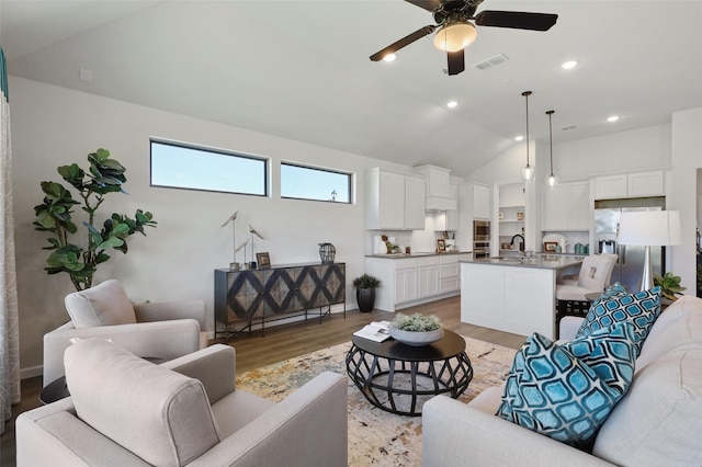 1417 Red Clover Ave, Van Alstyne, TX 75495 - living area featuring light wood-type flooring, a ceiling fan, and lofted ceiling