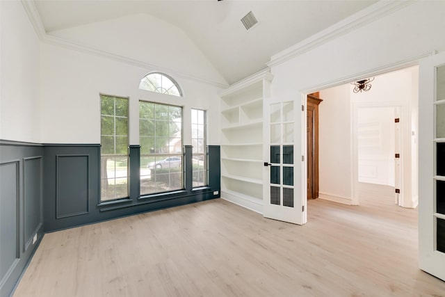 8209 Shoshoni Dr, Arlington, TX 76002 - unfurnished room featuring light wood finished floors, vaulted ceiling, a decorative wall, wainscoting, and ornamental molding