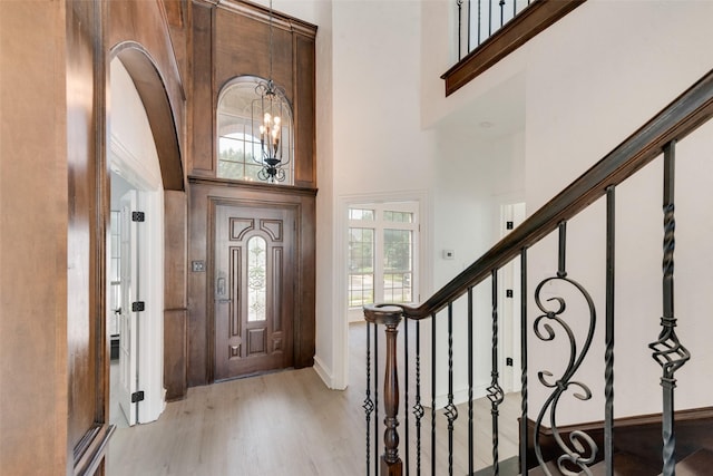 8209 Shoshoni Dr, Arlington, TX 76002 - entryway with light wood-style floors, a high ceiling, baseboards, stairs, and a chandelier