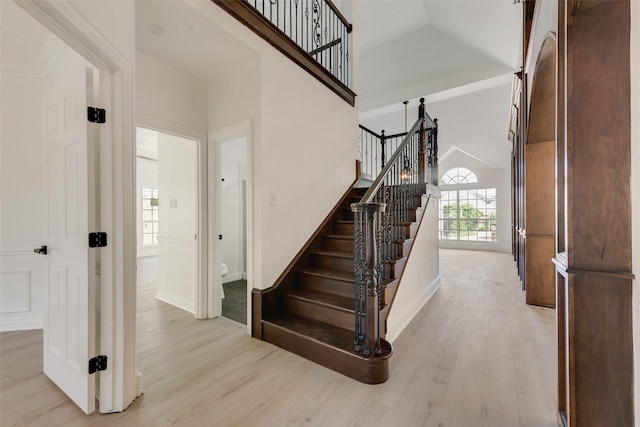 8209 Shoshoni Dr, Arlington, TX 76002 - stairway featuring wood finished floors, a towering ceiling, and baseboards