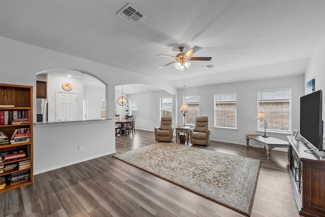 3128 Autry Rd, Lorena, TX 76655 - living area featuring arched walkways, a ceiling fan, plenty of natural light, and wood finished floors