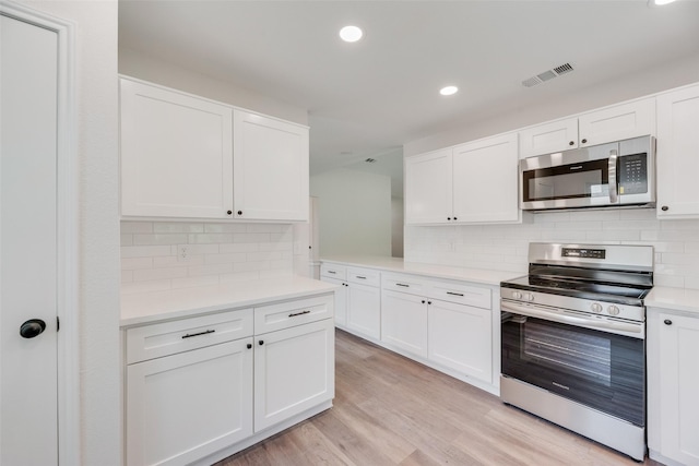 6102 Azalea Dr, Rowlett, TX 75089 - kitchen with stainless steel appliances, white cabinetry, light countertops, backsplash, and recessed lighting
