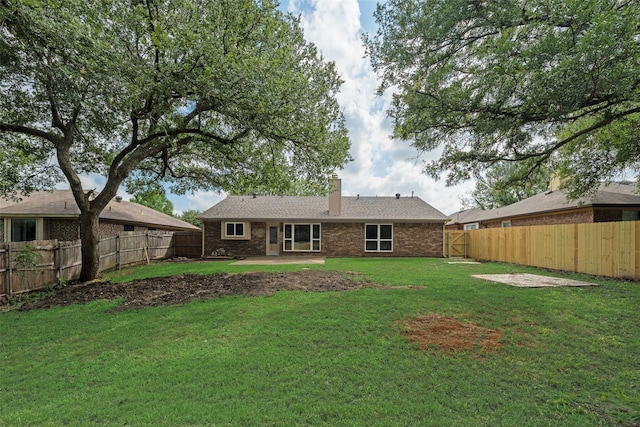 6102 Azalea Dr, Rowlett, TX 75089 - back of property featuring a chimney, a patio area, and brick siding