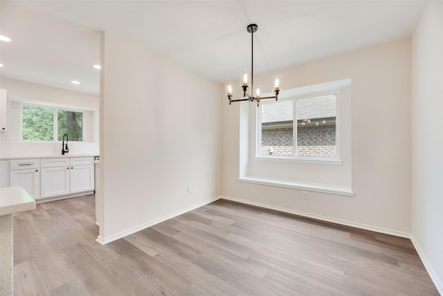 6102 Azalea Dr, Rowlett, TX 75089 - unfurnished dining area with light wood-style floors, a chandelier, a sink, recessed lighting, and baseboards