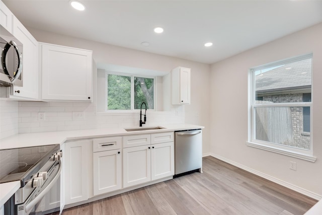6102 Azalea Dr, Rowlett, TX 75089 - kitchen with stainless steel appliances, a sink, decorative backsplash, light countertops, and white cabinetry