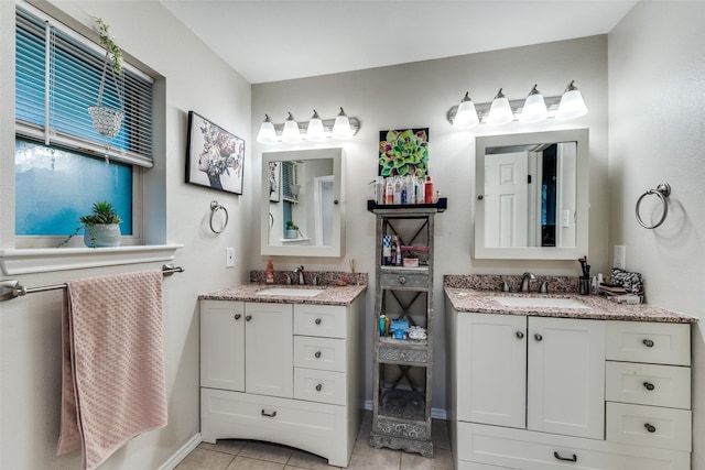 4920 Brookhollow Dr, Sachse, TX 75048 - bathroom featuring two vanities, tile patterned floors, and baseboards