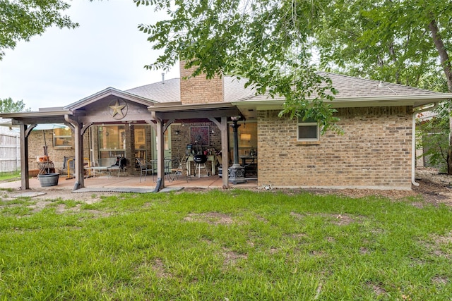 4920 Brookhollow Dr, Sachse, TX 75048 - back of house featuring a patio area, brick siding, a yard, a chimney, and a shingled roof