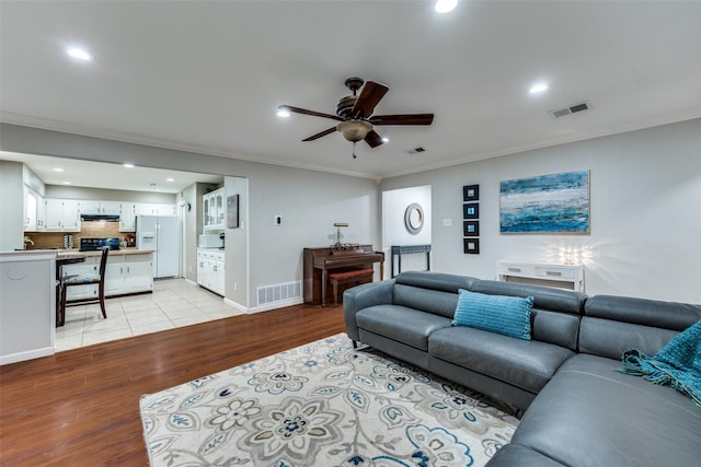4920 Brookhollow Dr, Sachse, TX 75048 - living area with light wood-type flooring, ornamental molding, ceiling fan, recessed lighting, and baseboards