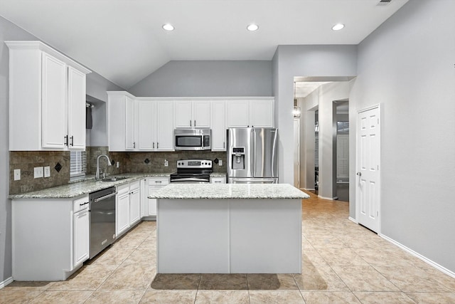 313 Owen Oaks Dr, Lake Dallas, TX 75065 - kitchen with stainless steel appliances, backsplash, white cabinets, a center island, and light stone countertops