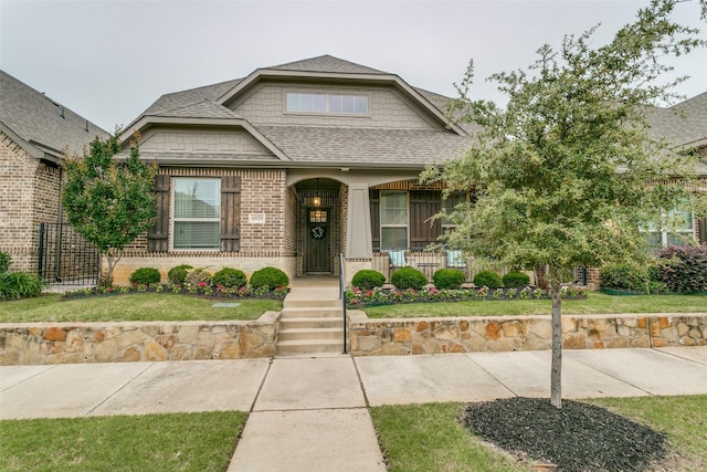 6929 Heather Ln, North Richland Hills, TX 76182 - view of front of home featuring a shingled roof, brick siding, covered porch, and a front lawn