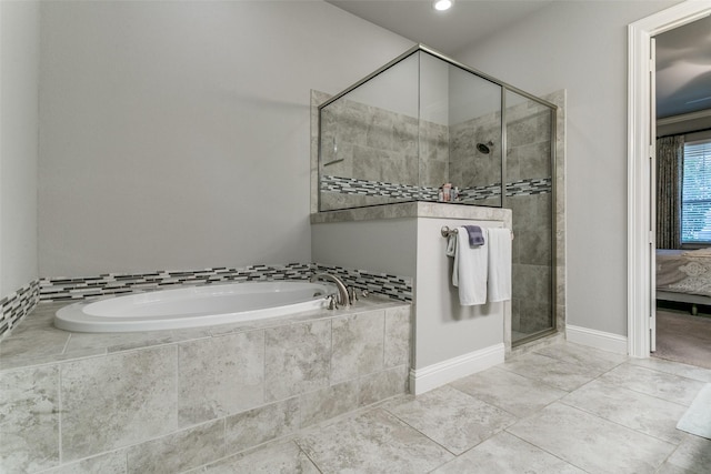 6929 Heather Ln, North Richland Hills, TX 76182 - bathroom featuring a garden tub, a stall shower, baseboards, ensuite bath, and tile patterned flooring