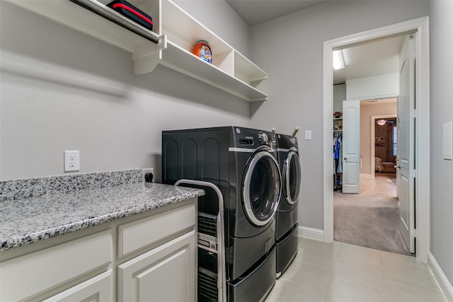 6929 Heather Ln, North Richland Hills, TX 76182 - washroom featuring washing machine and clothes dryer, baseboards, light tile patterned flooring, and light colored carpet