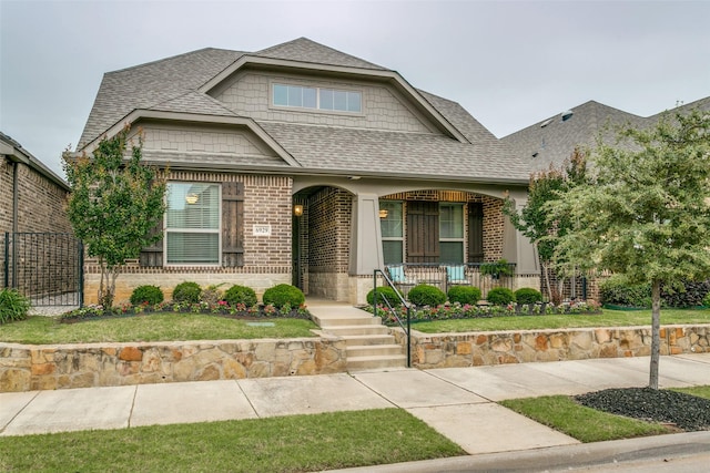 6929 Heather Ln, North Richland Hills, TX 76182 - view of front of property with roof with shingles, a porch, and brick siding