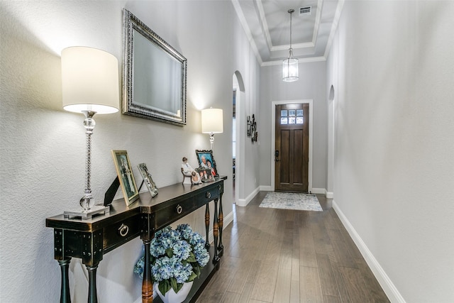 6929 Heather Ln, North Richland Hills, TX 76182 - entrance foyer with crown molding, dark wood-style flooring, baseboards, and arched walkways
