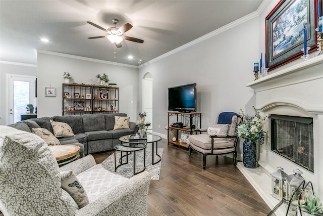 6929 Heather Ln, North Richland Hills, TX 76182 - living room with arched walkways, a fireplace with raised hearth, ceiling fan, dark wood-type flooring, and baseboards