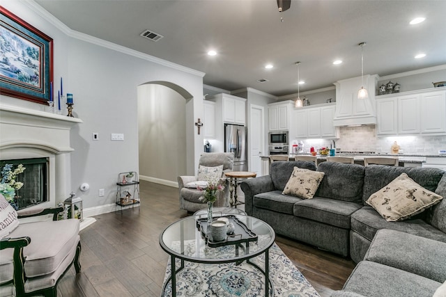 6929 Heather Ln, North Richland Hills, TX 76182 - living area with arched walkways, dark wood-type flooring, ornamental molding, recessed lighting, and baseboards