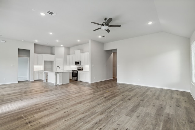 1426 Red Clover Ave, Van Alstyne, TX 75495 - unfurnished living room featuring a ceiling fan, recessed lighting, light wood finished floors, baseboards, and vaulted ceiling