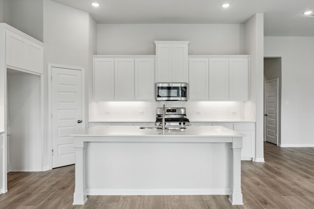 1426 Red Clover Ave, Van Alstyne, TX 75495 - kitchen with appliances with stainless steel finishes, an island with sink, light countertops, white cabinetry, and recessed lighting