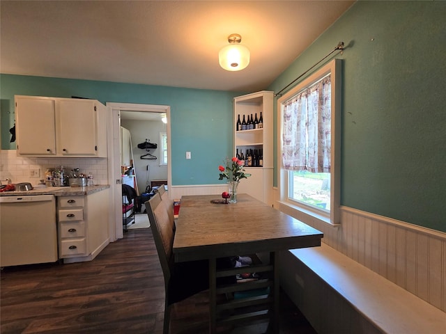 703 Jeanell St, Quitman, TX 75783 - dining space with dark wood-style floors and a wainscoted wall