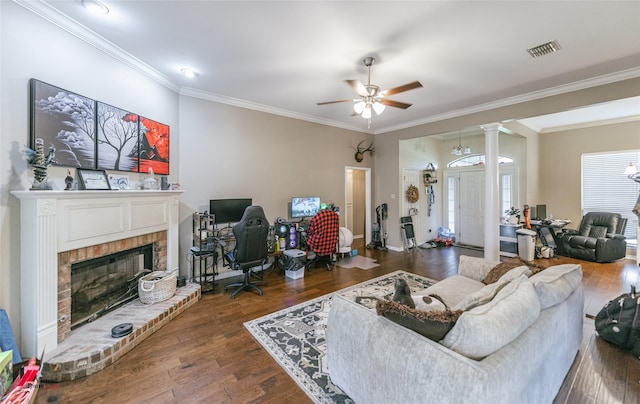 6008 Pepperwood Cir, Bossier City, LA 71111 - living room featuring crown molding, a brick fireplace, a ceiling fan, ornate columns, and wood finished floors