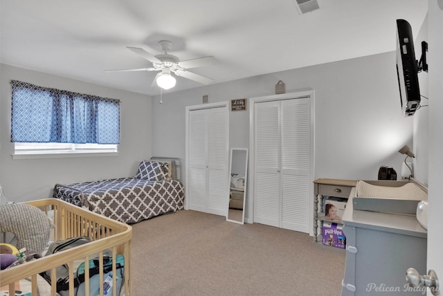 9346 Shartel Dr, Shreveport, LA 71118 - bedroom featuring two closets, carpet, and a ceiling fan