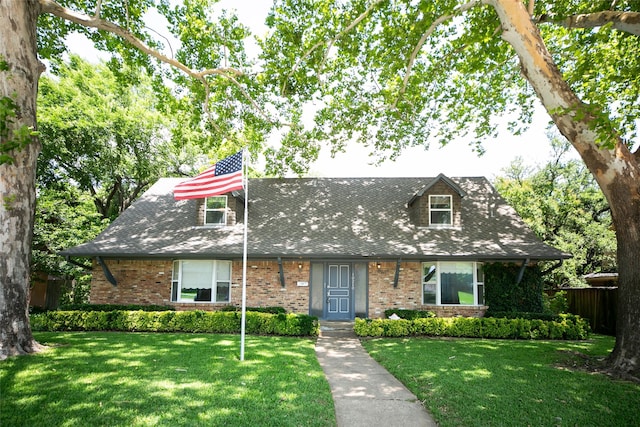 10210 E Lk Highlands, Dallas, TX 75218 - view of front of home with a front yard, brick siding, and roof with shingles
