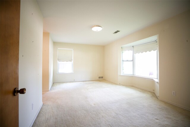 10210 E Lk Highlands, Dallas, TX 75218 - empty room featuring plenty of natural light, light colored carpet, and baseboards