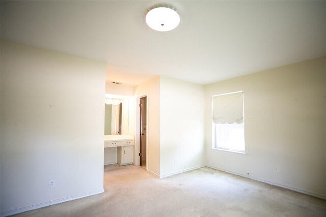 10210 E Lk Highlands, Dallas, TX 75218 - unfurnished bedroom featuring light colored carpet, baseboards, and connected bathroom