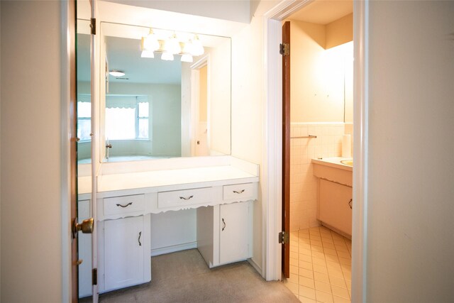 10210 E Lk Highlands, Dallas, TX 75218 - bathroom featuring vanity, wainscoting, tile walls, and tile patterned flooring
