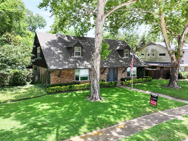 10210 E Lk Highlands, Dallas, TX 75218 - english style home featuring brick siding and a shingled roof