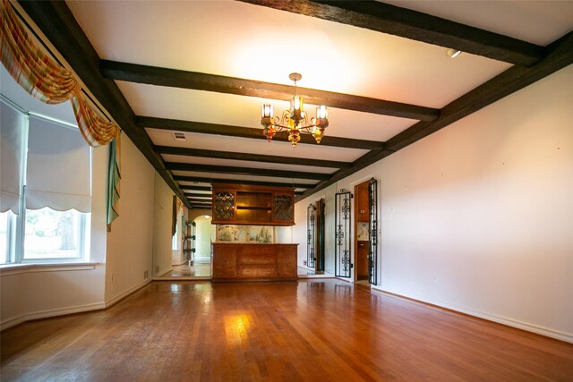 10210 E Lk Highlands, Dallas, TX 75218 - unfurnished living room featuring beamed ceiling, a chandelier, wood finished floors, and baseboards