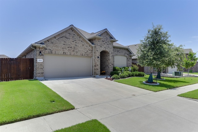 1541 Seabiscuit Dr, Granbury, TX 76049 - view of front of property with a garage, driveway, and brick siding
