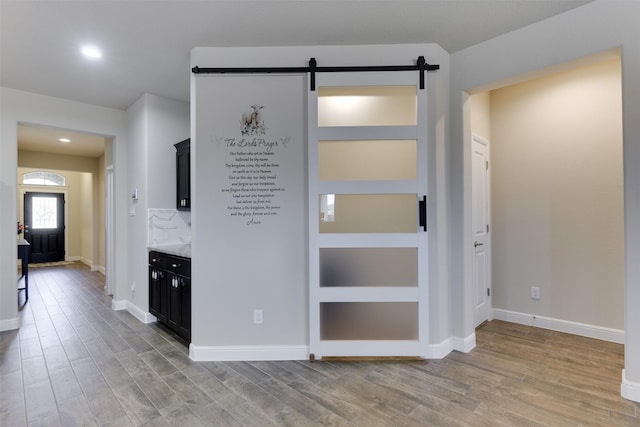 1541 Seabiscuit Dr, Granbury, TX 76049 - interior space featuring light wood-type flooring, a barn door, baseboards, and recessed lighting