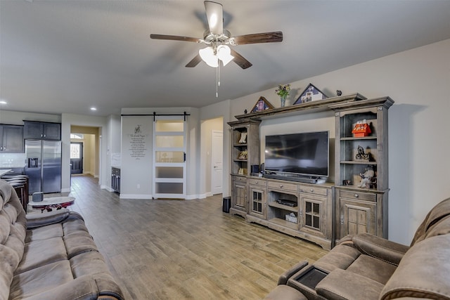 1541 Seabiscuit Dr, Granbury, TX 76049 - living area with ceiling fan, a barn door, baseboards, light wood finished floors, and recessed lighting