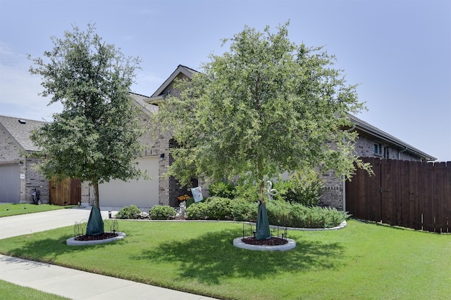 1541 Seabiscuit Dr, Granbury, TX 76049 - obstructed view of property with brick siding, a garage, and concrete driveway