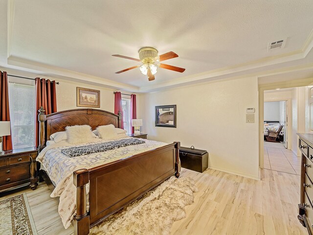 4640 Versailles Ln, Plano, TX 75093 - bedroom with a raised ceiling, crown molding, and light wood finished floors