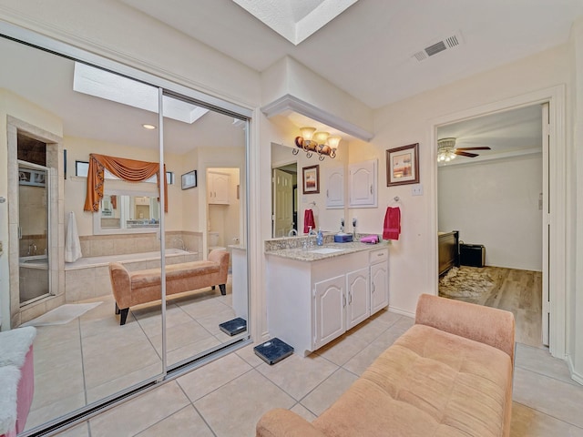 4640 Versailles Ln, Plano, TX 75093 - bathroom featuring vanity, a bath, tile patterned floors, a shower stall, and ceiling fan