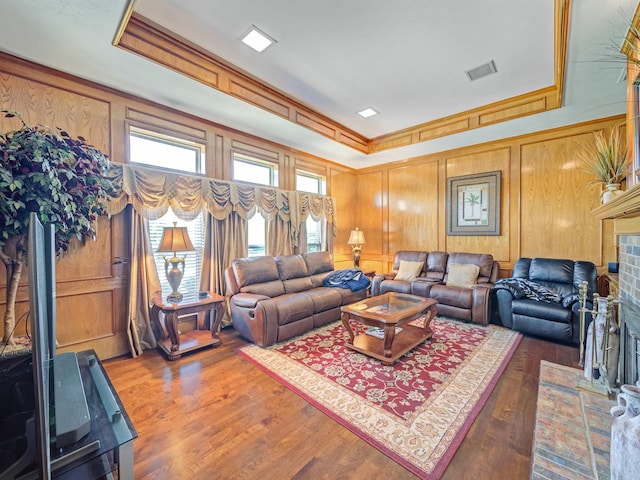 4640 Versailles Ln, Plano, TX 75093 - living area with crown molding, wood finished floors, a tray ceiling, and wooden walls