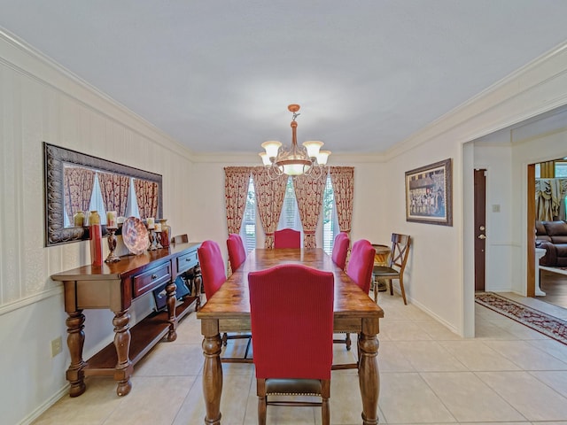 4640 Versailles Ln, Plano, TX 75093 - dining area featuring a chandelier, crown molding, light tile patterned floors, and baseboards