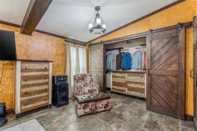 2283 US Highway 281 N, Jacksboro, TX 76458 - sitting room with a barn door, vaulted ceiling, dark stone finish floors, and crown molding
