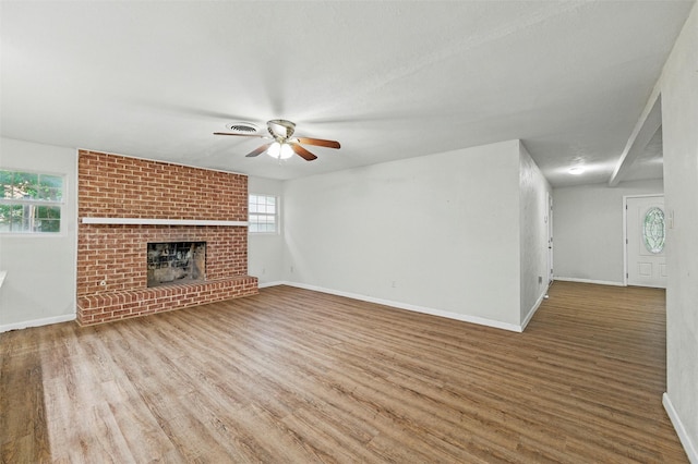 325 Belmont St, Hurst, TX 76053 - unfurnished living room featuring a ceiling fan, wood finished floors, and a fireplace