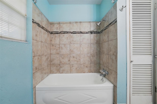 325 Belmont St, Hurst, TX 76053 - bathroom featuring a textured wall and shower / tub combination