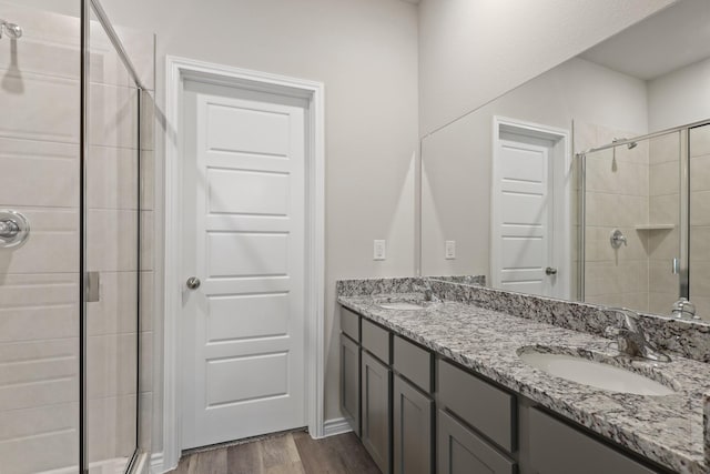 10620 Stag Ln, Fort Worth, TX 76036 - bathroom featuring a shower stall, double vanity, and wood finished floors
