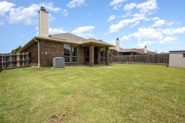 7609 Velvet Antler Trl, Arlington, TX 76002 - rear view of house with brick siding, a chimney, and cooling unit