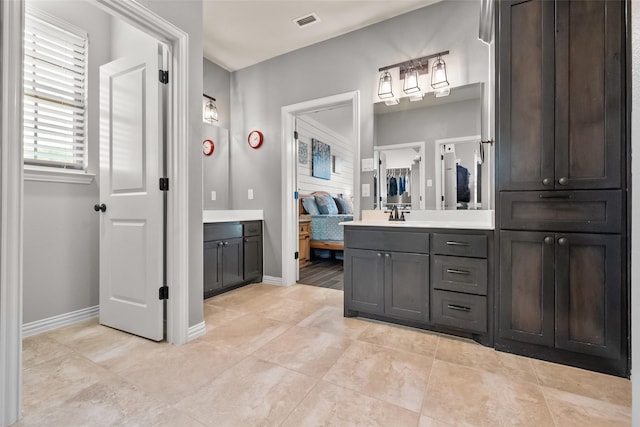 15070 Fm 916, Maypearl, TX 76064 - bathroom with connected bathroom, vanity, tile patterned flooring, and baseboards