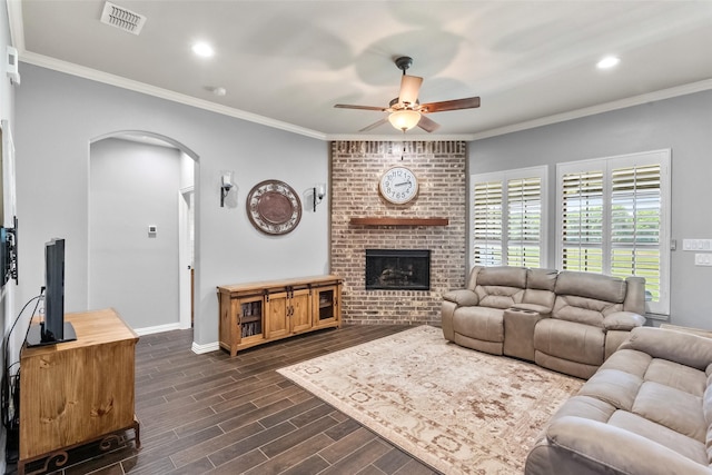 15070 Fm 916, Maypearl, TX 76064 - living area featuring arched walkways, ceiling fan, baseboards, dark wood-type flooring, and a fireplace