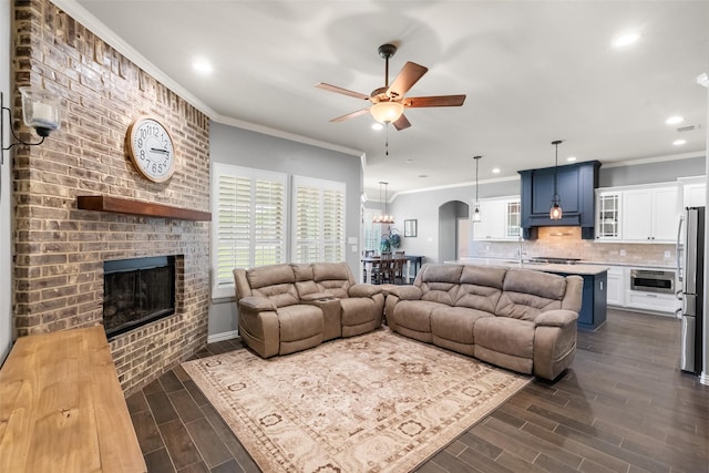 15070 Fm 916, Maypearl, TX 76064 - living area with a ceiling fan, recessed lighting, a fireplace, dark wood-style flooring, and crown molding